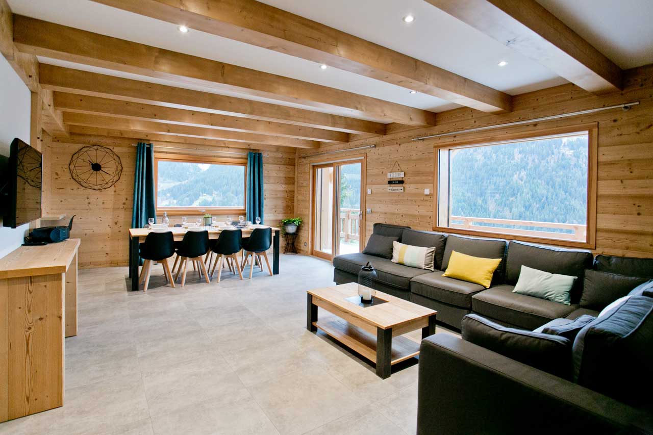 entrée du chalet accès salon séjour et cuisine écran plat salle à manger 12 personnes